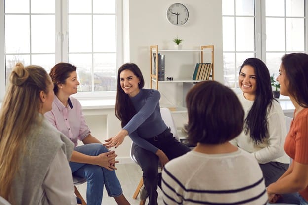 A women's support group meeting in a circle